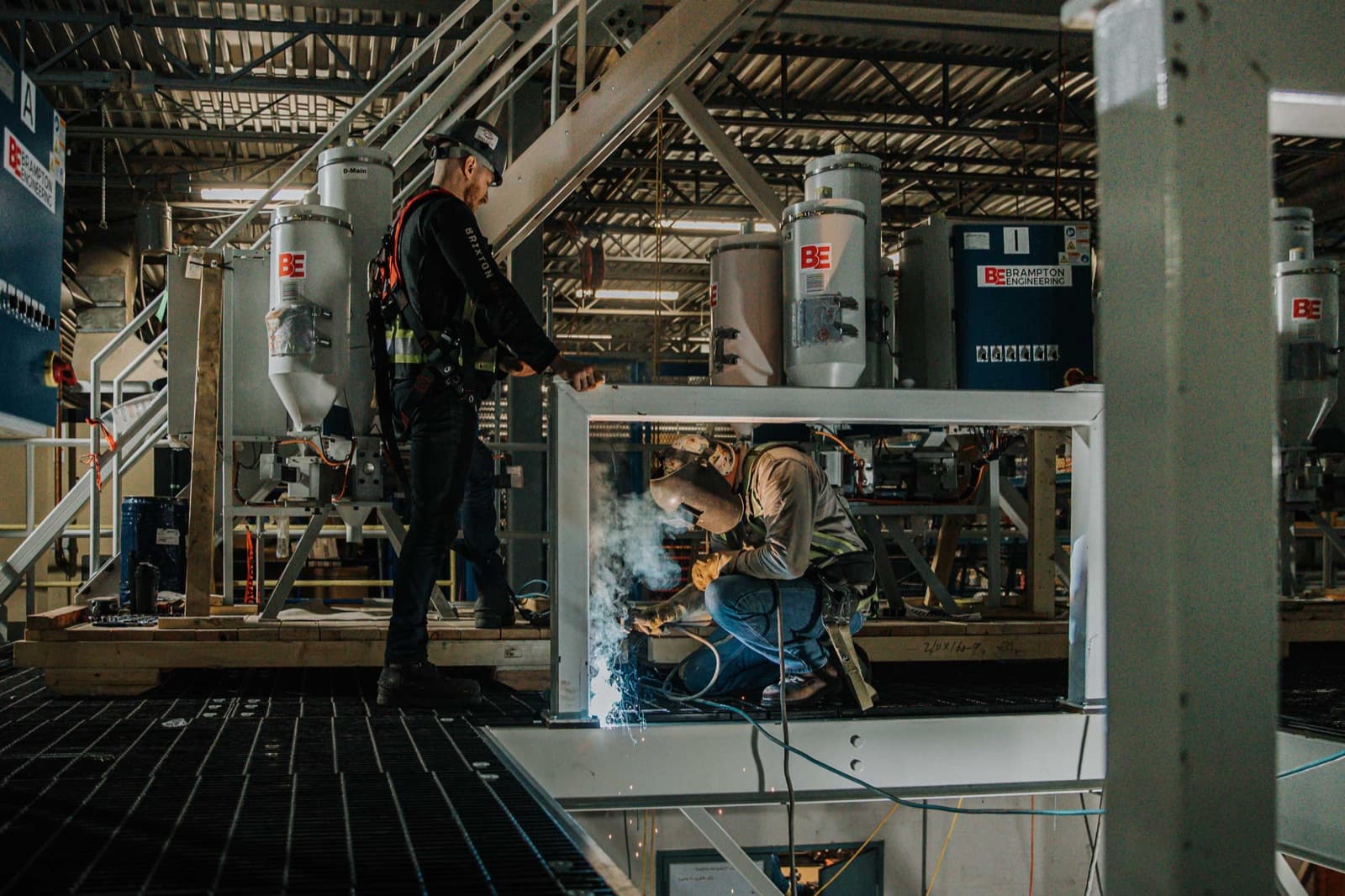 Valley Industrial Services crew welding steel framing on a plant mezzanine